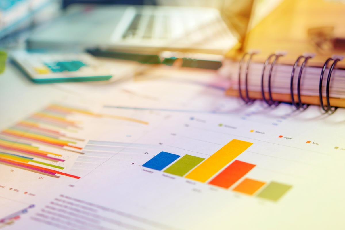 Colorful graph chart on a desk in front of a spiral notebook