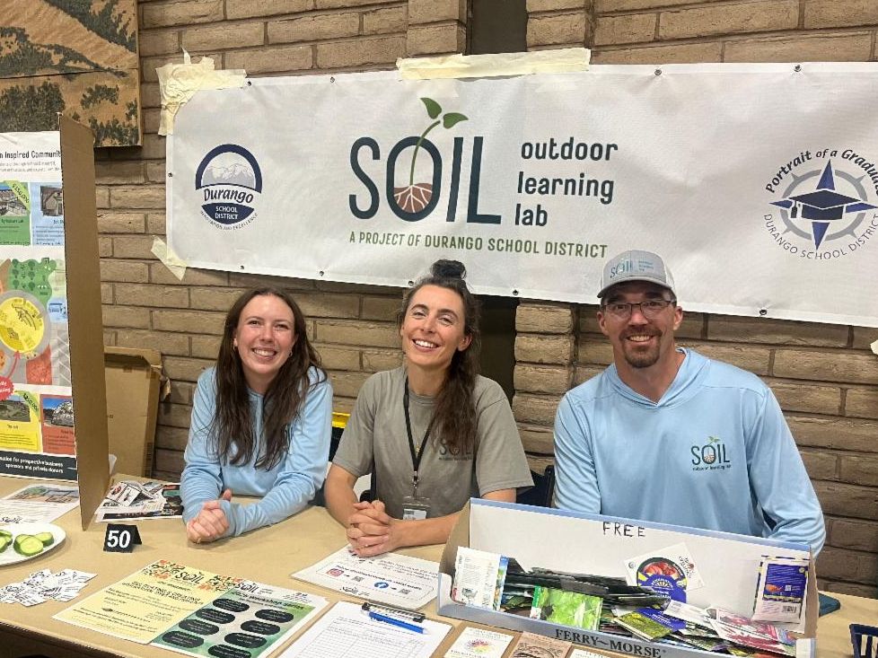 Staff pose at a tabling event