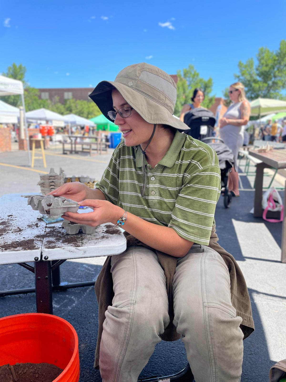Intern leads a kids' activity at the farmers market