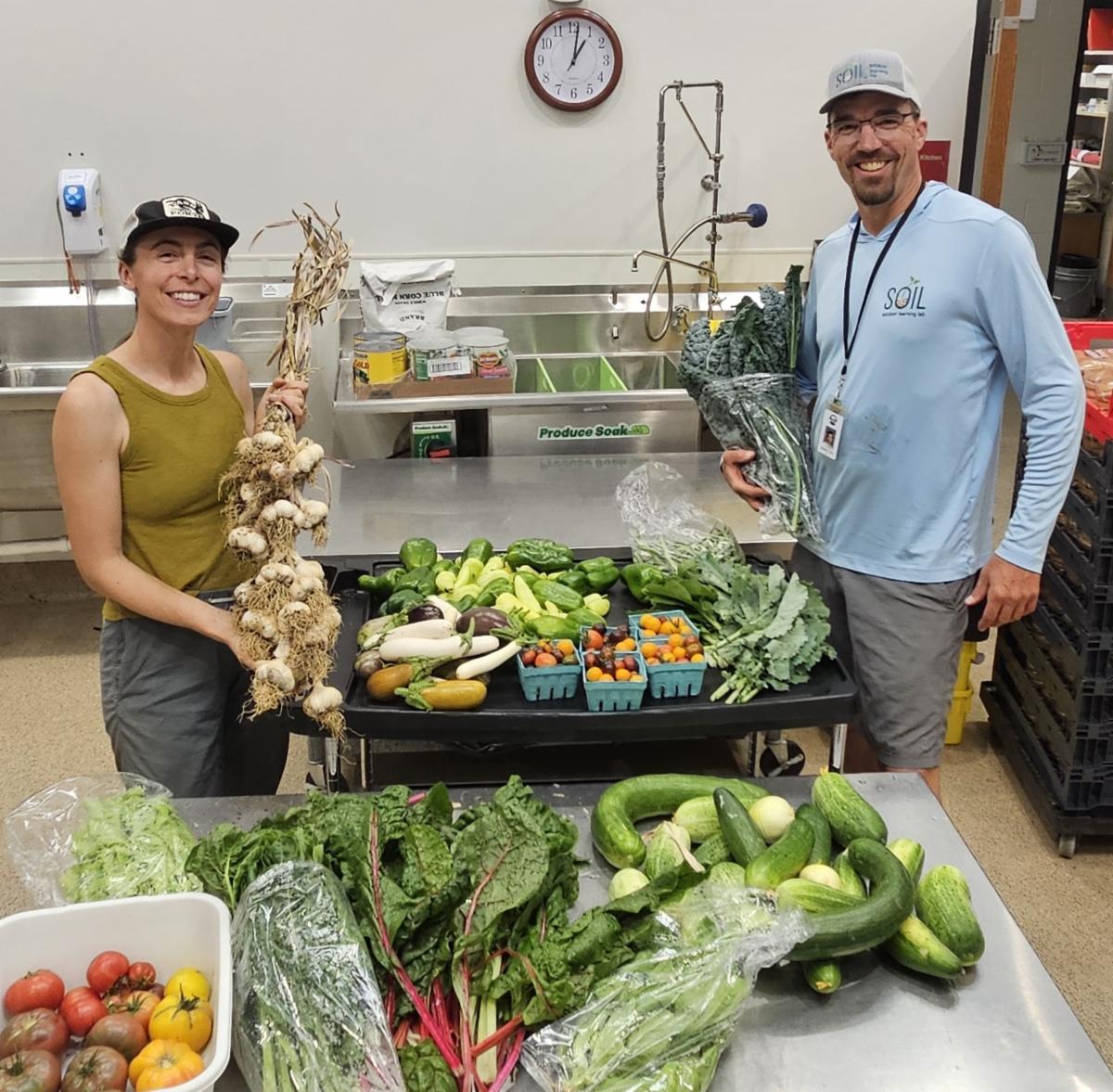SOIL staff pose with harvest from the garden