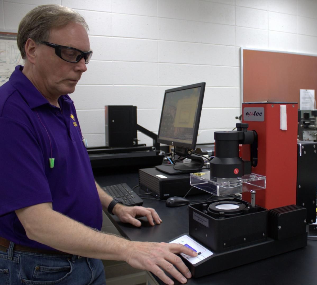 Man works at a tissue softness analyzer.