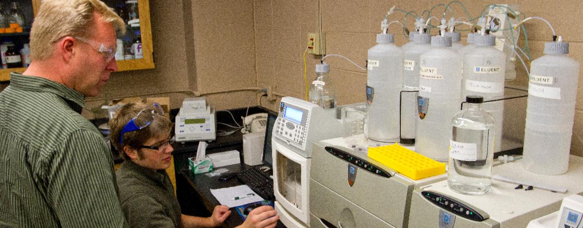 WIST's Eric Singsaas and Justin Hall look at laboratory equipment.