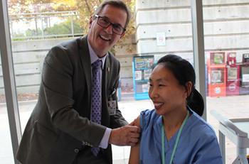 North York General Hospital President and CEO Dr. Tim Rutledge gives the flu shot to Hye Youn Kim, a Team Attendant in the Surgery Short Stay Unit, at the launch of the 2016 flu campaign on Oct. 18.