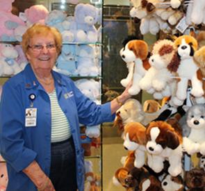 Barb Liddiard, Chair of the Volunteer Services Gift Shop, is surrounded by a wide selection of popular plush toys from the General site's Gift Shop.