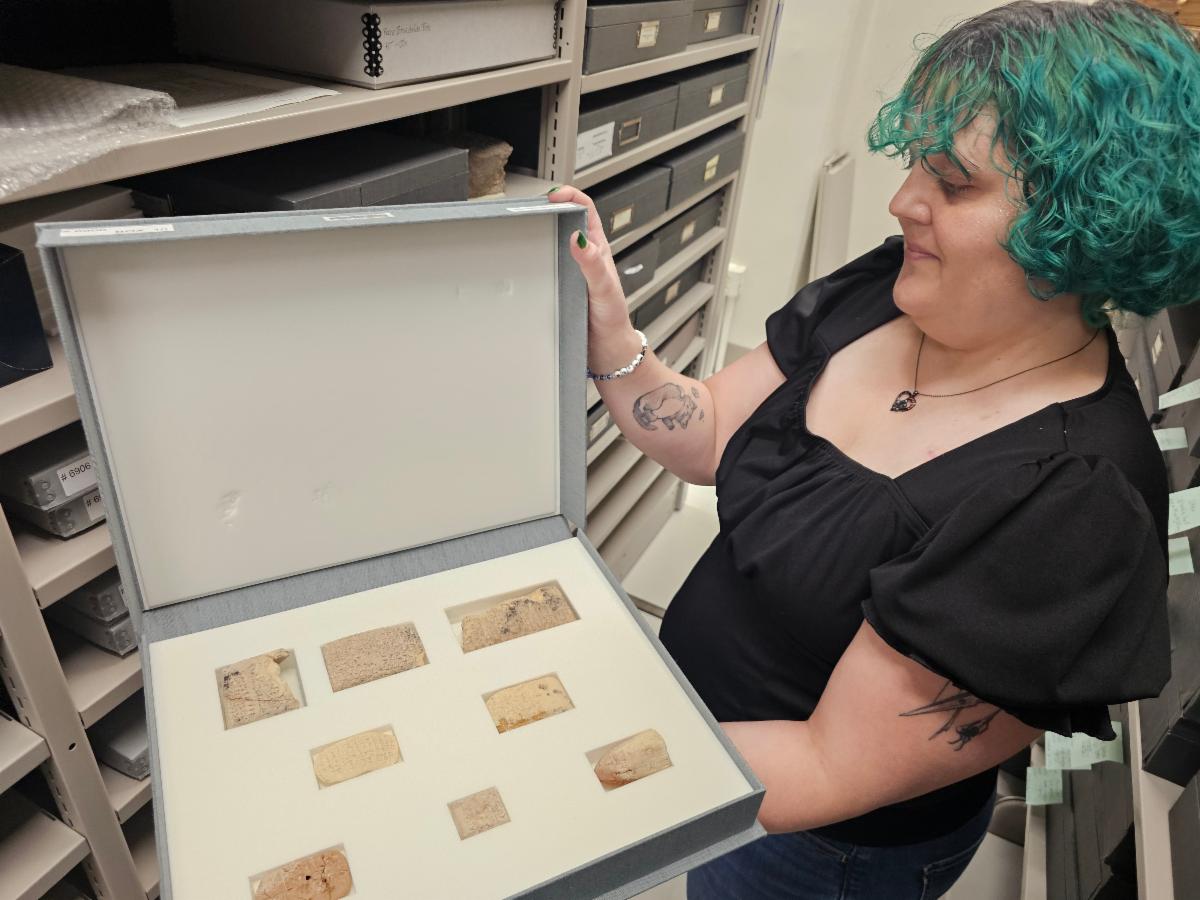 Tabitha Cary holding a box with cuneiform tablets