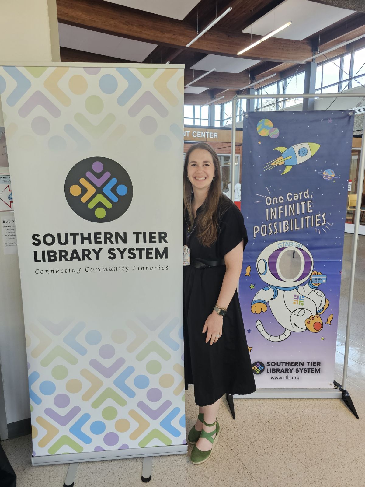 Erika Jenns stands with an STLS banner