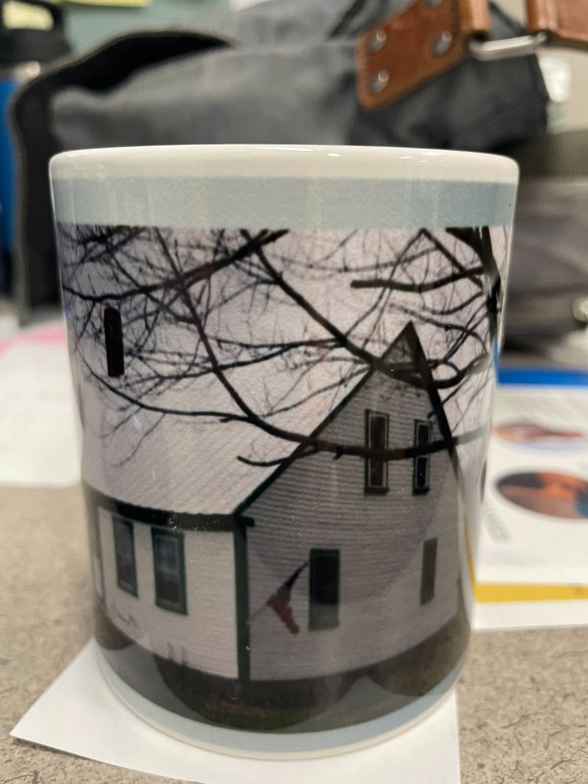 Photo of mug with picture of Milton Bradleys childhood home