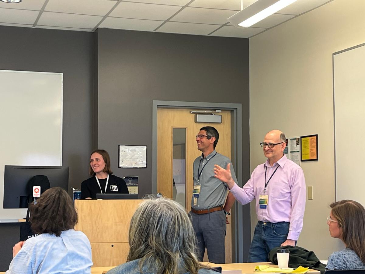 Photo of Lindsay Decker, Matthew Revitt and Jerry Lund speaking before a group of people.