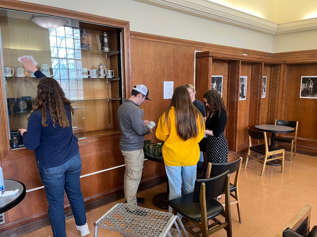 Photo of All Maine Women and Senior Skulls members cleaning steins