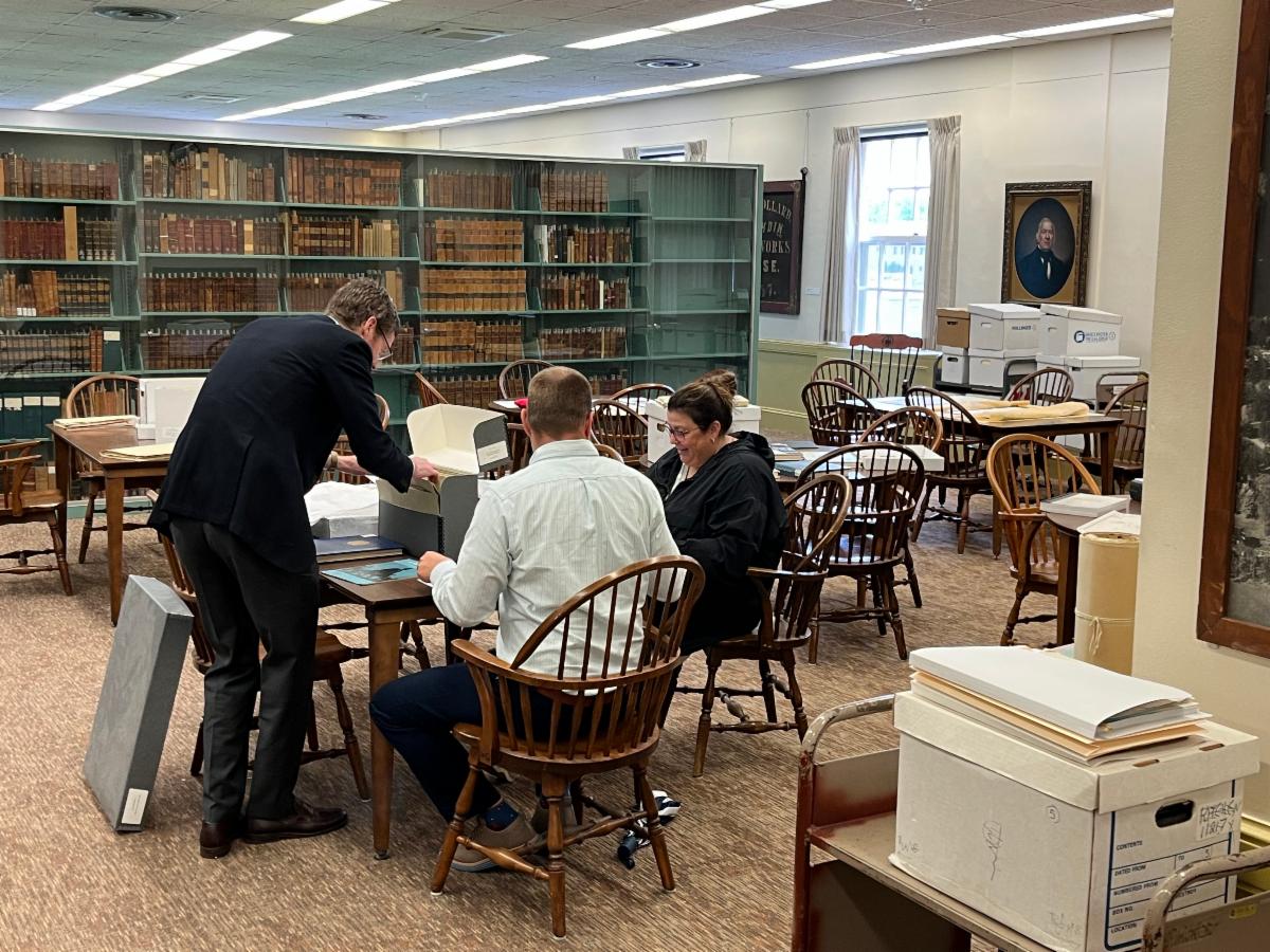 Photo of General Counsel staff examining the JFK collection