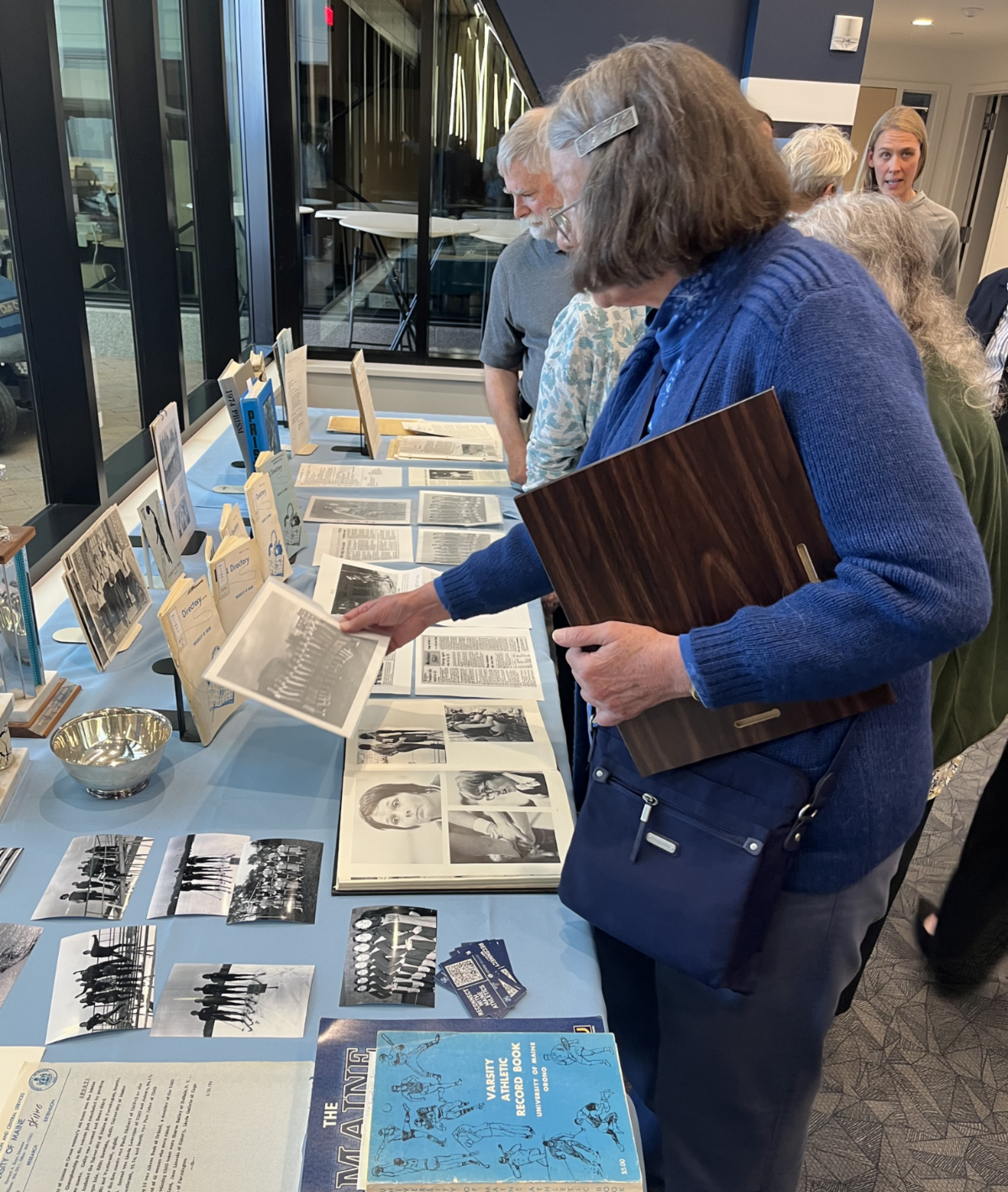 Photo of people looking at a display of memorabilia