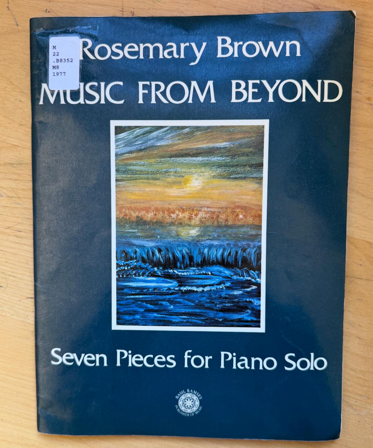 Photo of a songbook featuring a scene with waves and the sun