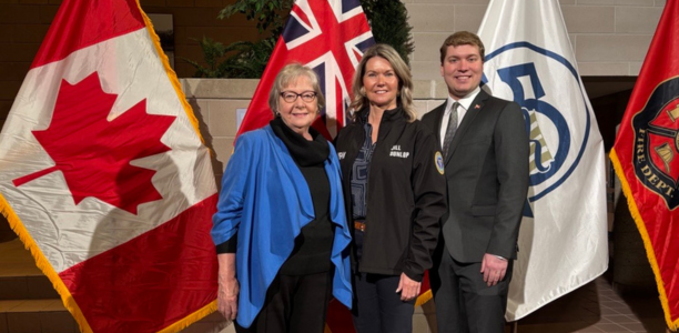 Photo of Mayor Lawlor, Minister Jill Dunlop, and MPP Joseph Racinsky at Town Hall standing in front of flags.
