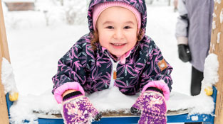 Young girl playing in snow