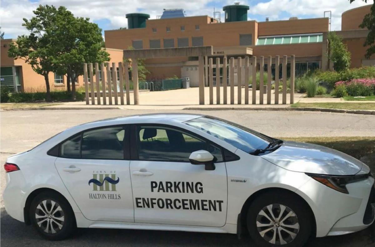 Town of Halton Hills parking enforcement white car in front of the town hall