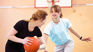 Youth girls playing basketball