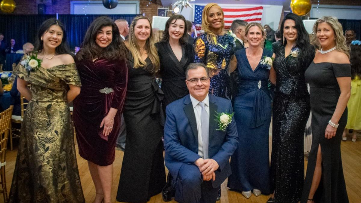 Members of the Everett City Council pose together with Mayor Robert Van Campen kneeling in front.