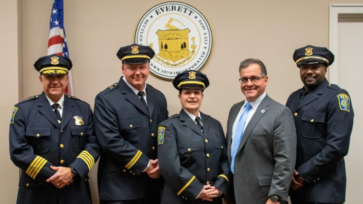 Promoted Everett police officers stand with Mayor Robert Van Campen and Police Chief Paul Strong during a recognition ceremony.