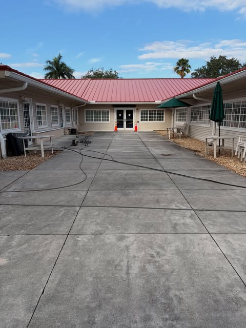 Clean concrete courtyard walkway at a commercial property after pressure washing