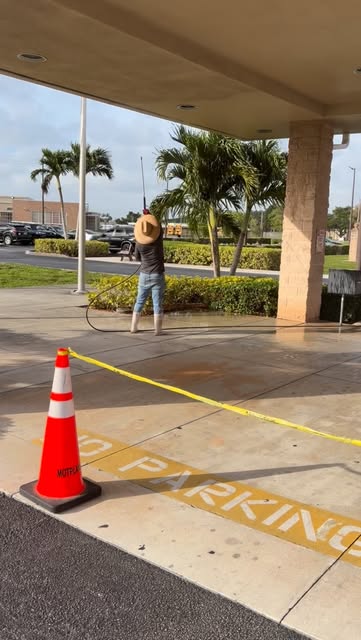 Our crew pressure washing a commercial building entrance in South Florida