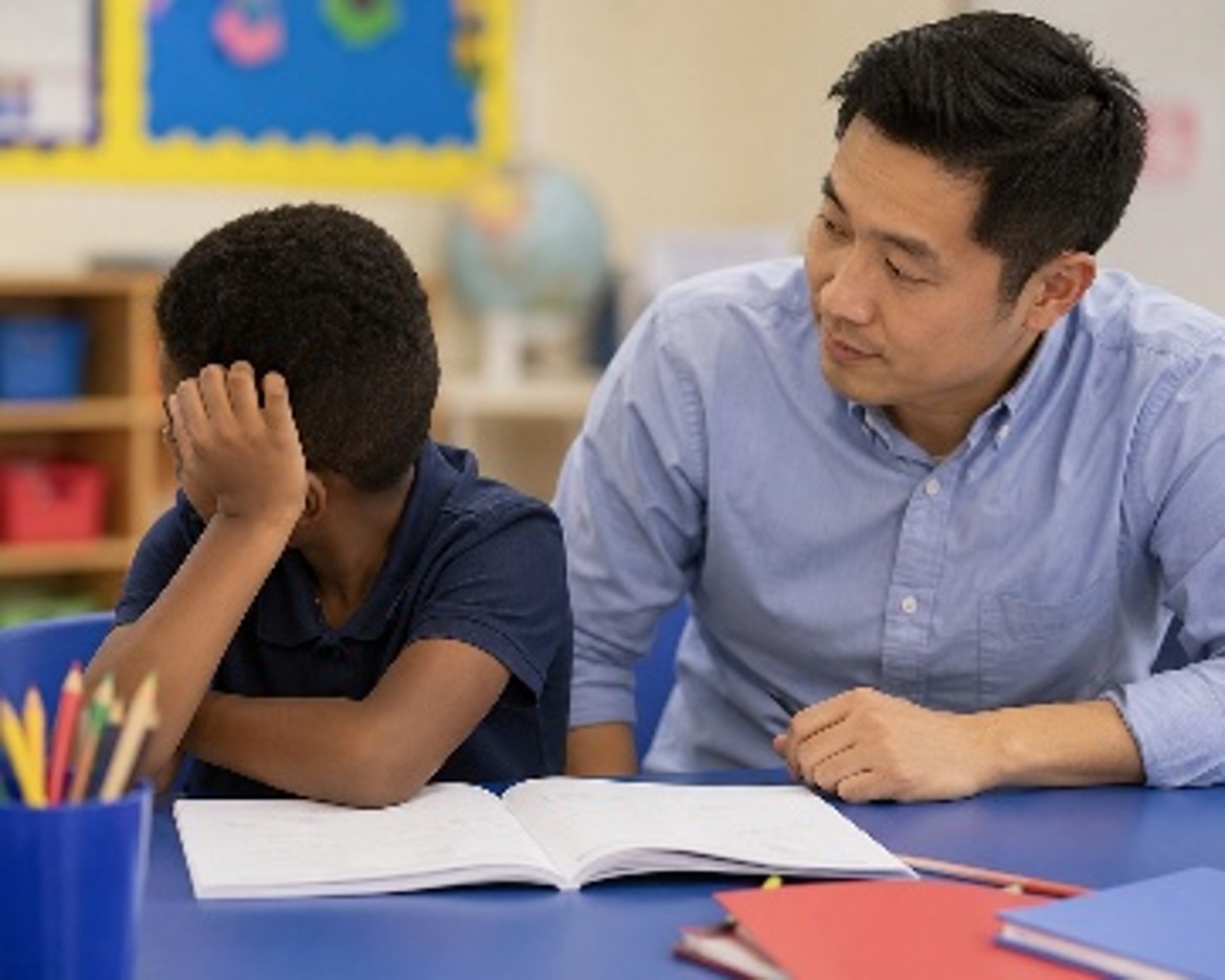 a child and a teacher at school