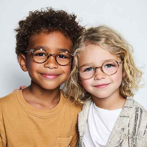 two preschool-aged children wearing glasses