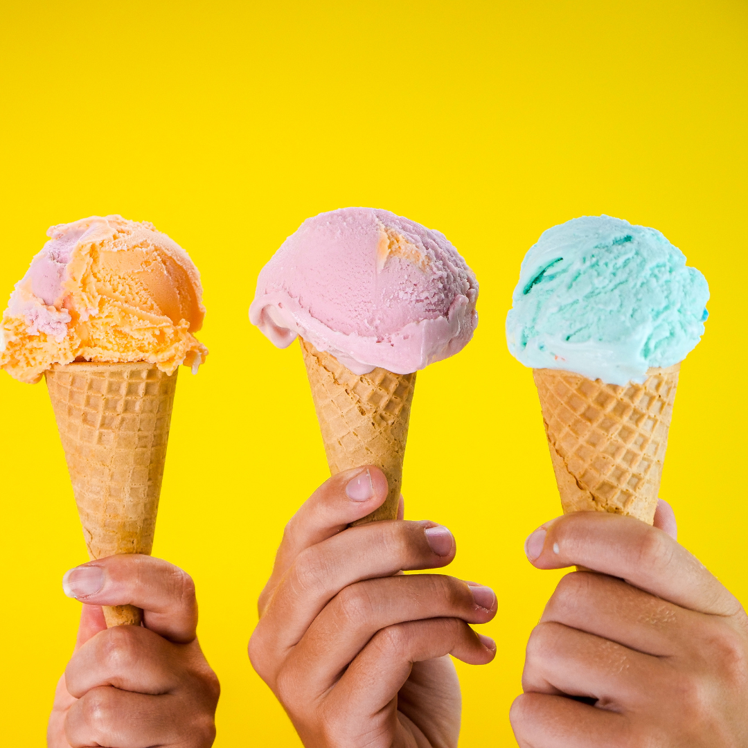 A photo of hands holding ice cream cones.