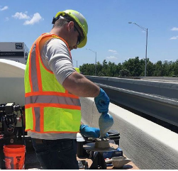 A worker conducts a slump test of freshly made
UHPC. This simple test helps verify the consistency of
a batch of concrete.