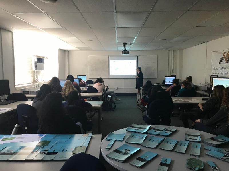 Ondine Wells, UFTI K-12 coordinator, presents to a classroom with middle school girls.