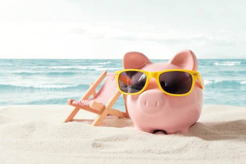Piggy bank resting on vacation. Saving money_ travel concept
