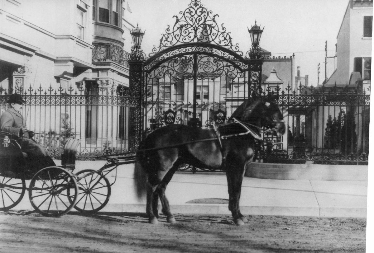 A horse and buggy in front of the Simon Mansion.