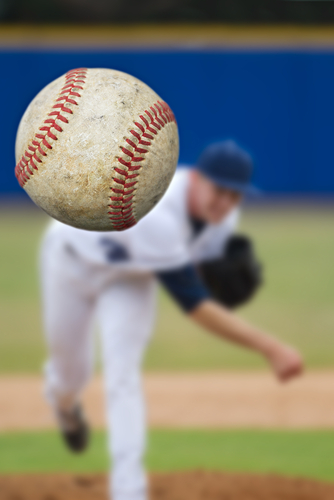 Baseball Pitcher Throwing focus on Ball