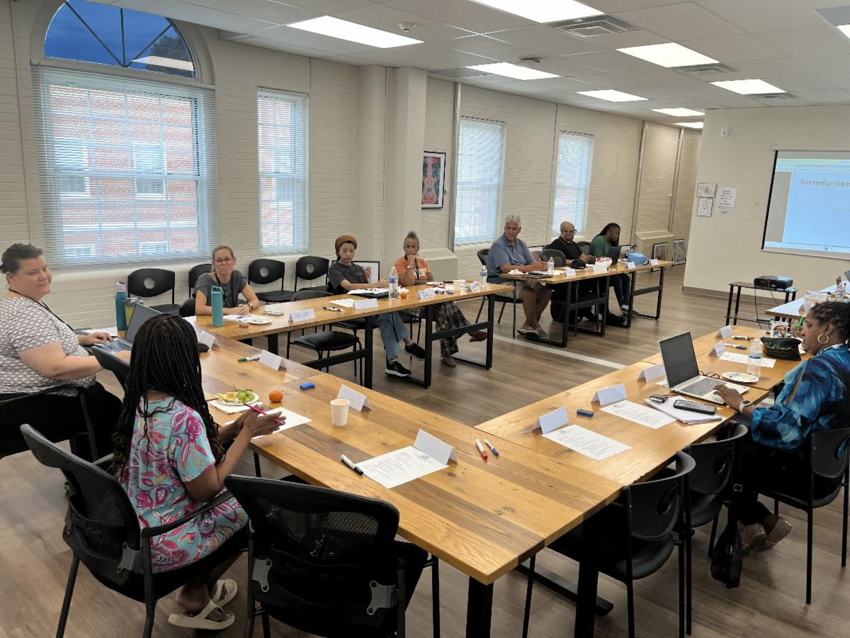People sitting around a meeting room