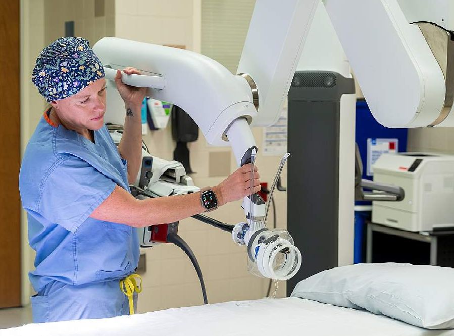 Kelly Hewitt, MD, demonstrates how the equipment is used in a robotic mastectomy.