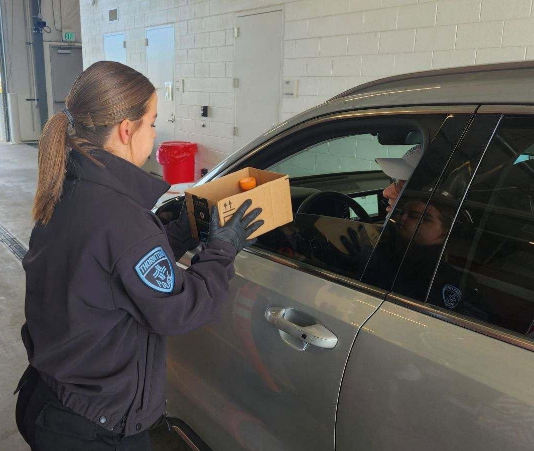 Thornton Police Explorer taking medications from person in vehicle