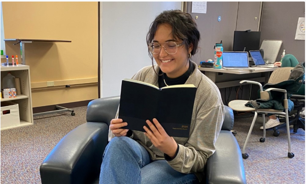 photo of student reading in an armchair