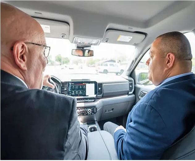 two men talking in ride share car front seat