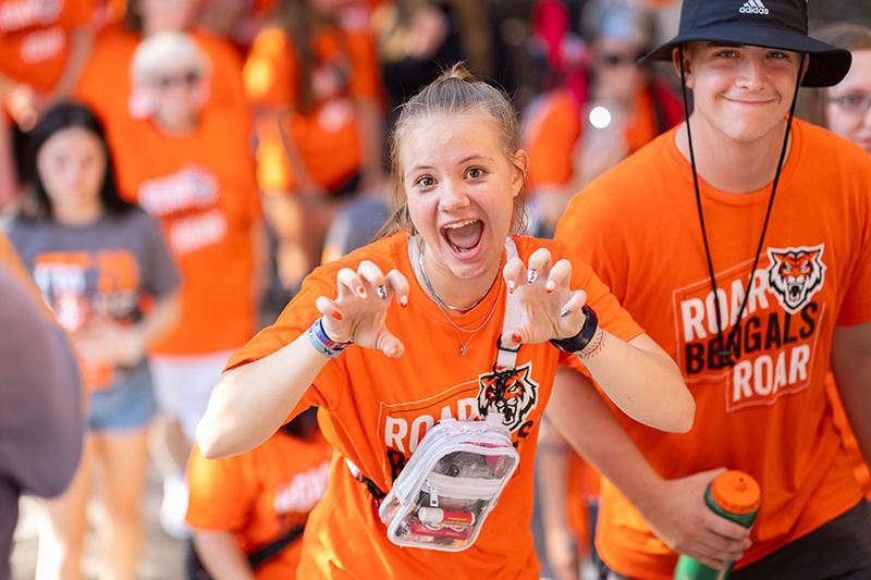 Student making ROAR signals with their hands