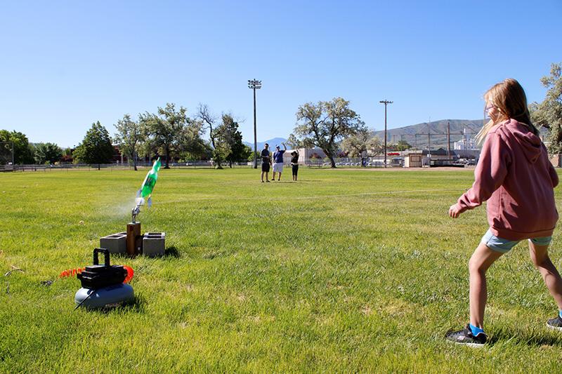Girl waits as her water rocket takes off