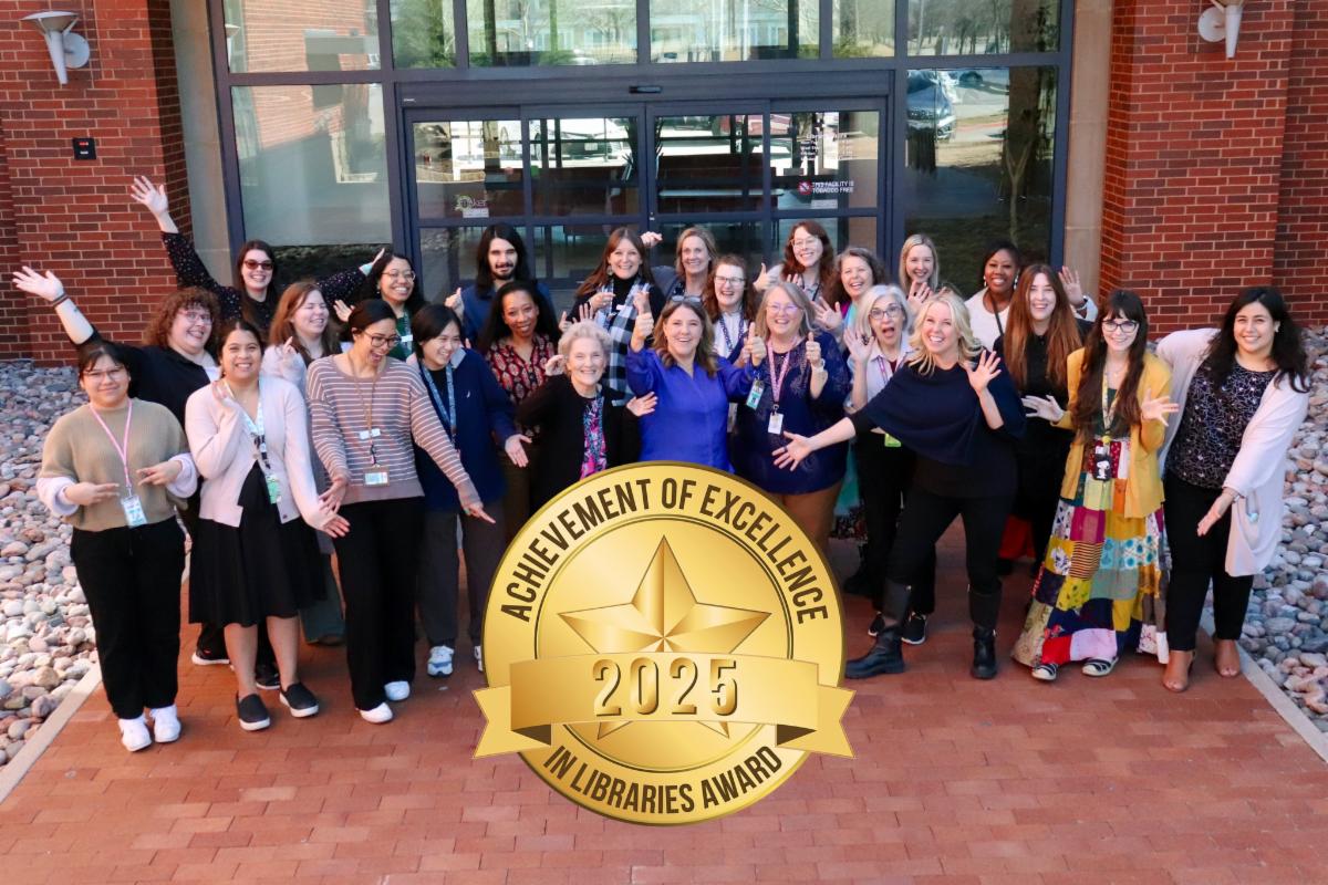 Group of NRH Library staff pose with thumbs up and waving. 2025 Achievement of Excellence award seal added to bottom of photo.
