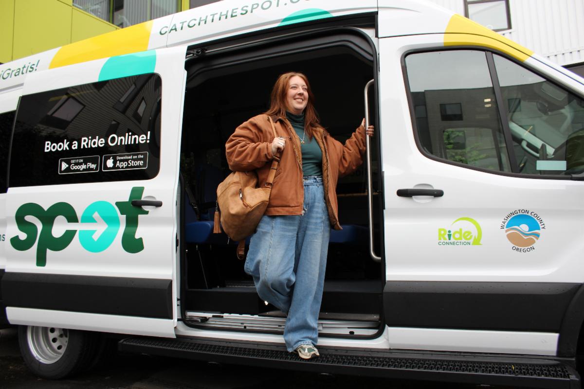 Contented woman gets off the SPOT shuttle at her destination