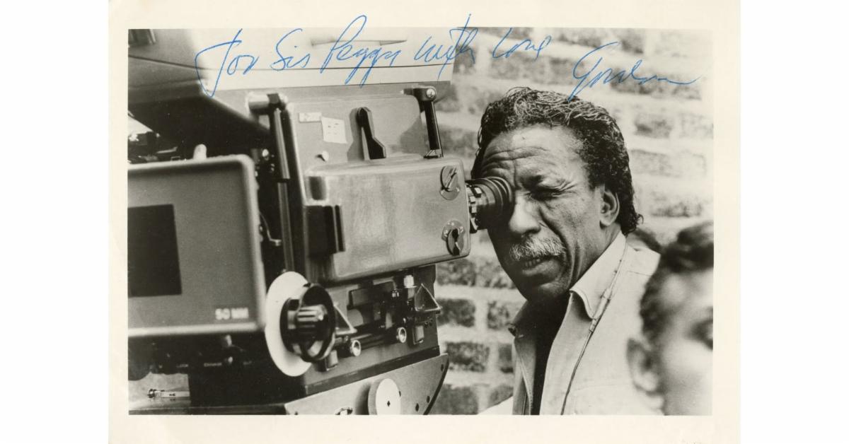 Signed photograph of Gordon Parks behind a movie camera