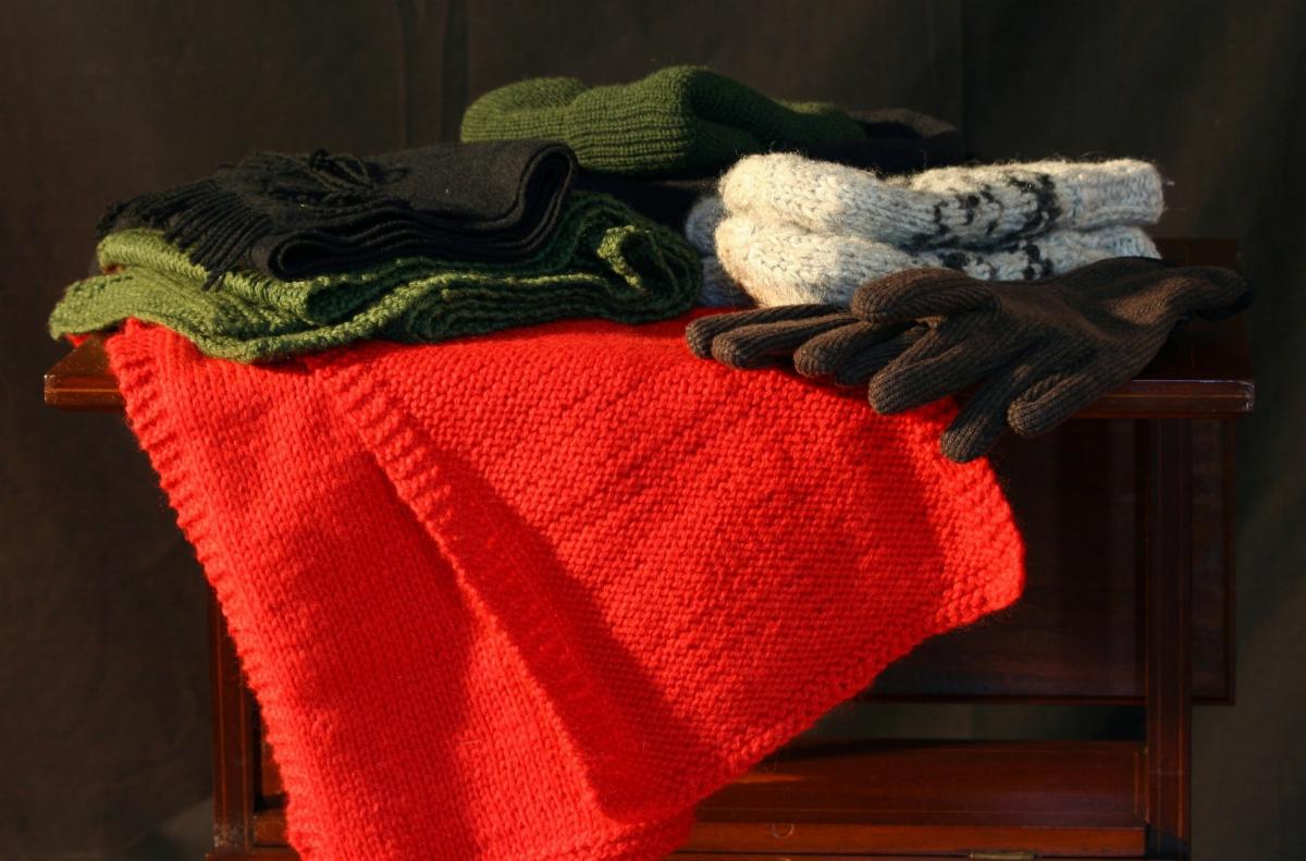 piles of scarves hats and mittens