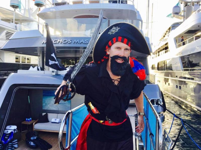 Crew member in pirate costume on the Crescent motor yacht MUCHOS MAS