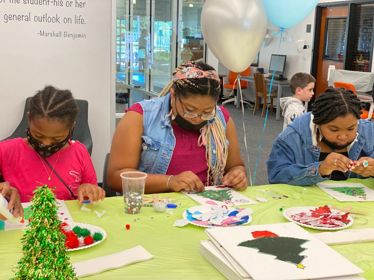 Three children doing Christmas Tree Crafts