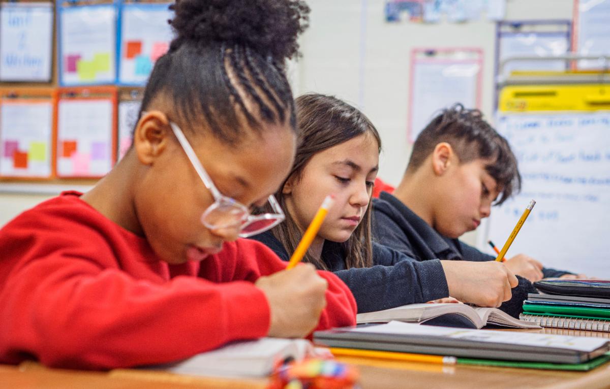 students writing in workbooks