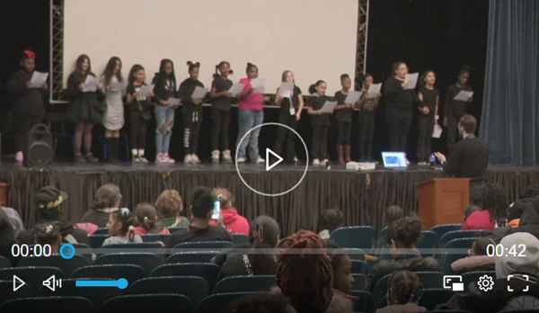 children on a stage in a video