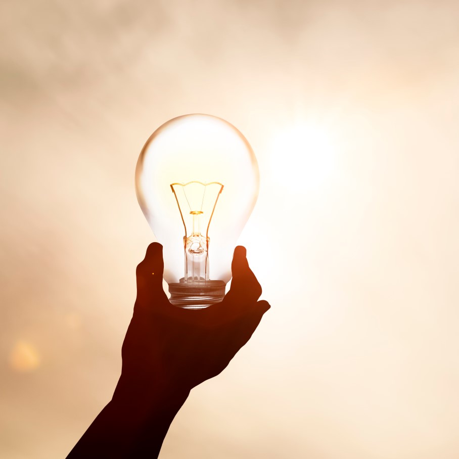 hand holding lightbulb outside