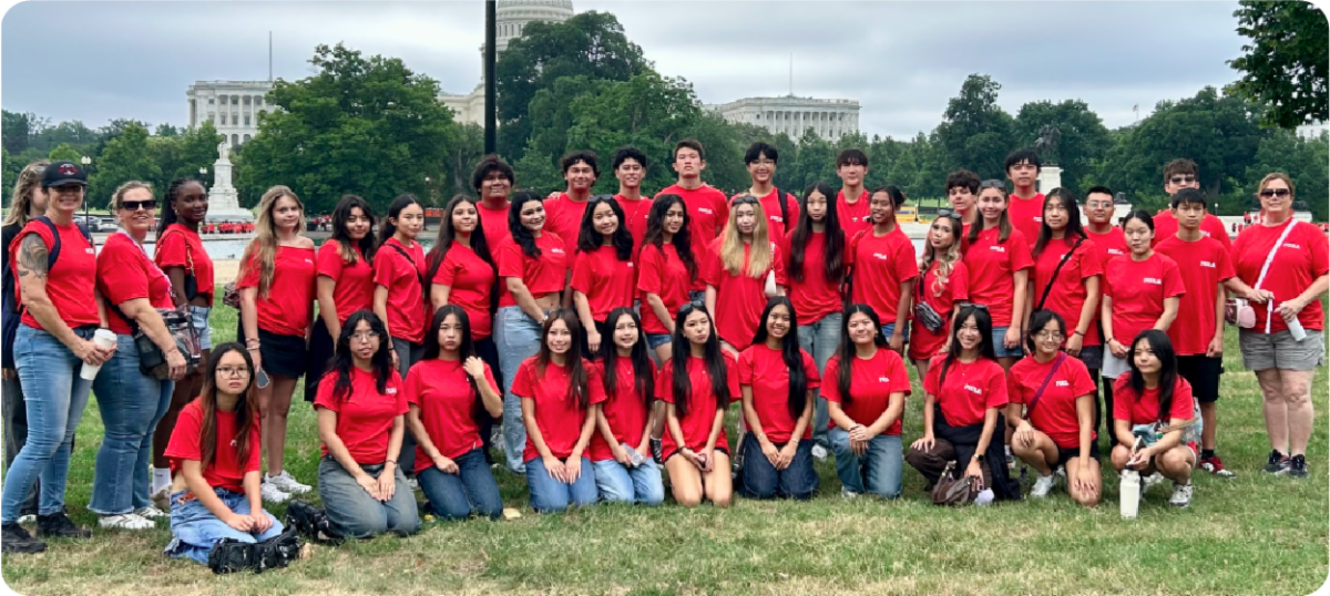 A large group of FCCLA students and educators wearing red shirts pose on the lawn in Washington, D.C., with the U.S. Capitol visible in the background.