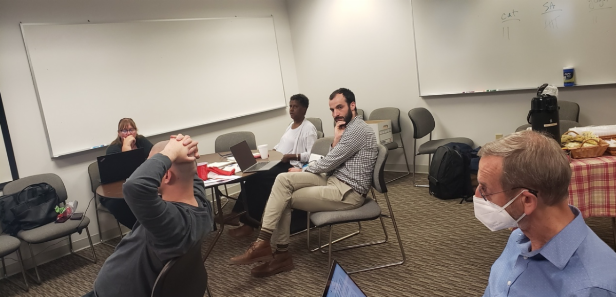 People sitting at tables in a conference room